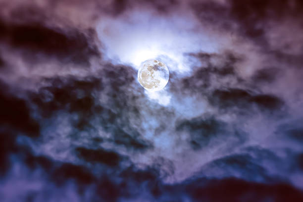 istock Nighttime sky with clouds and bright full moon with shiny. 627033012