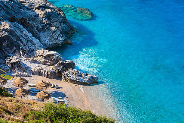 Summer Ionian sea coast, Albania. Morning summer Ionian sea coast and beach with transparent aquamarine water, Albania. albania stock pictures, royalty-free photos & images