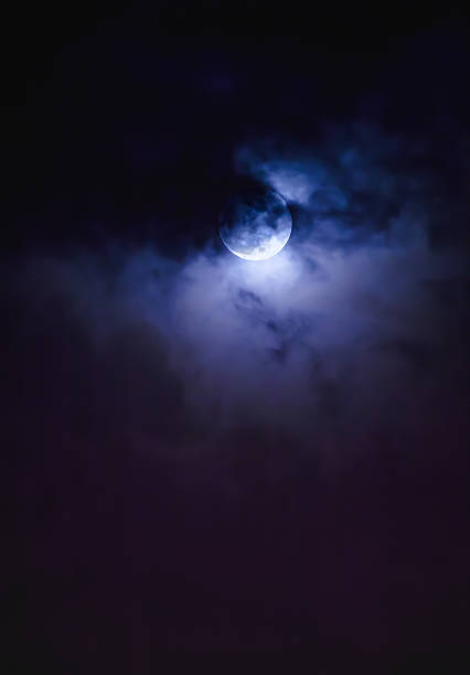 istock Nighttime sky with clouds and bright full moon with shiny. 627034908
