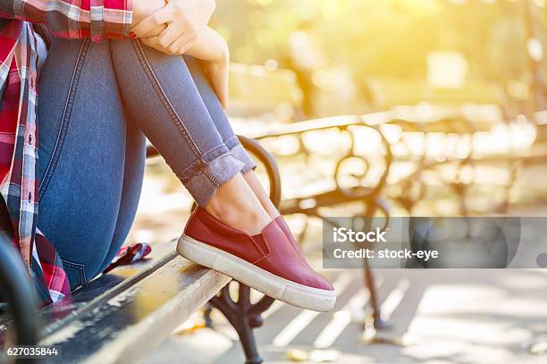 Sad Teenage Girl Sitting On The Park Bench Stock Photo - Download Image Now - Teenage Girls, Teenager, Adolescence
