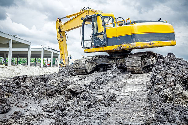 istock Excavator is preparing pile of ground for loading in truck. 627037160