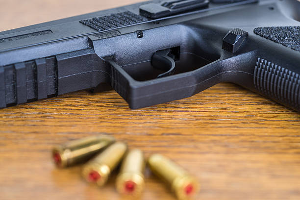 istock Close up view of bullets and handgun. 627037628