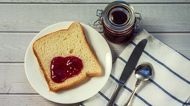 istock Toast with jam on wooden table. Top view 627039436