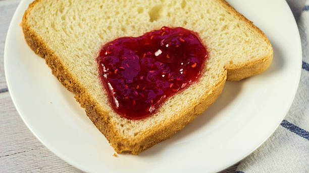 istock Toast with jam on wooden table. 627039458