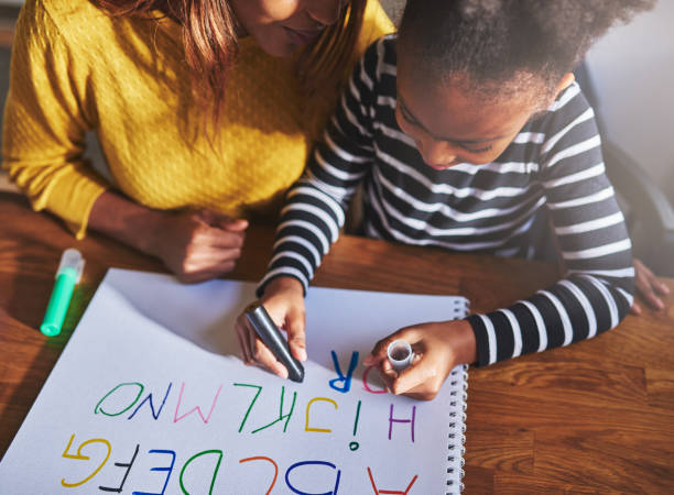 istock Overhead view of child learning alphabet 627039530