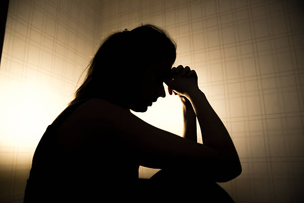 istock stressed young woman touching head and thinking 627040166