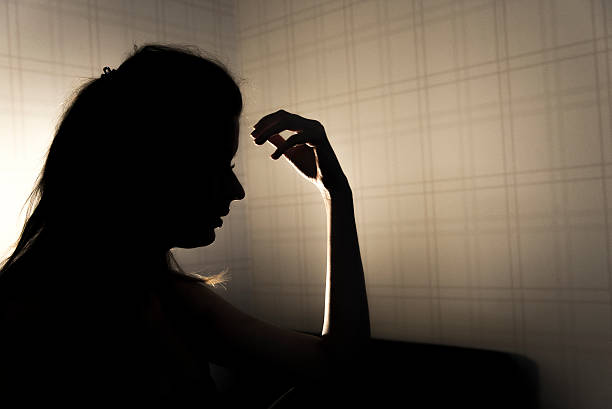 istock stressed young woman touching head and thinking at home 627040626