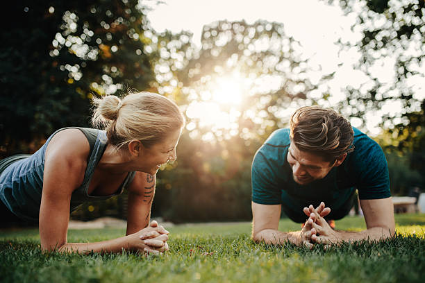 istock Caucasian couple doing core workout in park 627043988