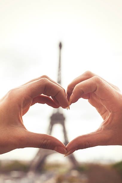 istock Close up of female hands making heart 627047626