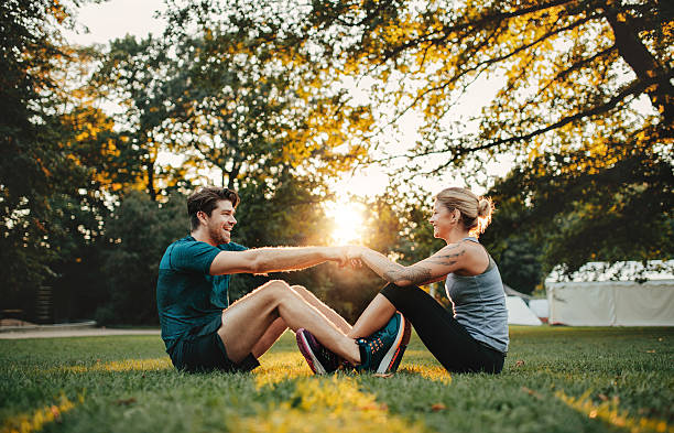 istock Young couple exercising together at park 627047880