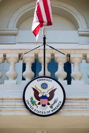 Chisinau, Moldova - September 11, 2016: An American flag and U.S. embassy seal hang outside the American embassy in Chisinau, Moldova.