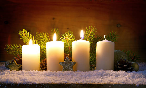 istock Three burning advent candles and Christmas decoration. 627068594