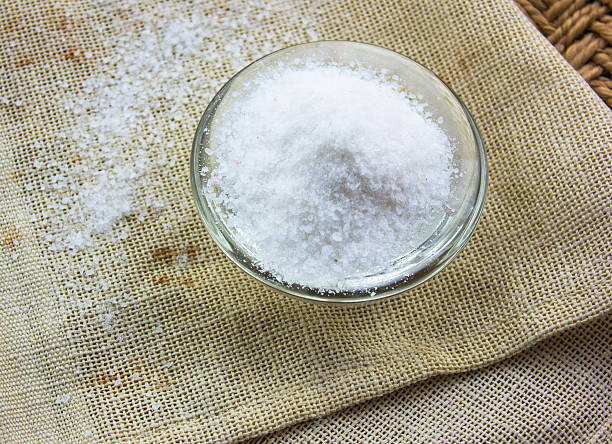 istock salt through the glass,background beige straw and cloth 627068626