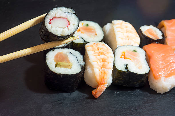 istock Pieces of sushi on a black stone 627068662