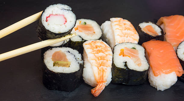 istock Pieces of sushi on a black stone 627069454