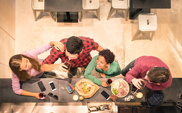 top view of multiracial friends tasting wine and having fun - gastro pub imagens e fotografias de stock