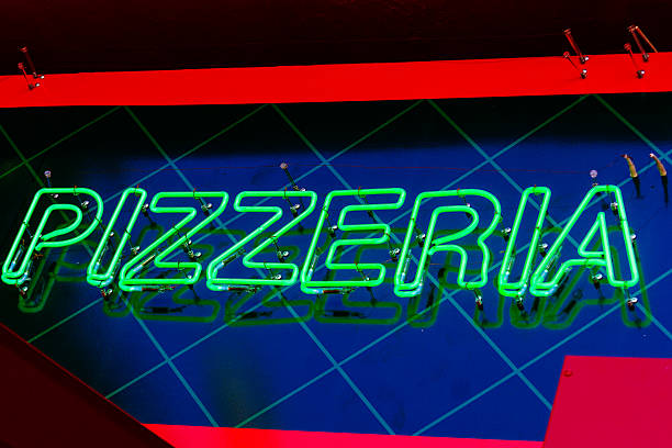 istock Neon sign on the front of a pizza shop 627070580