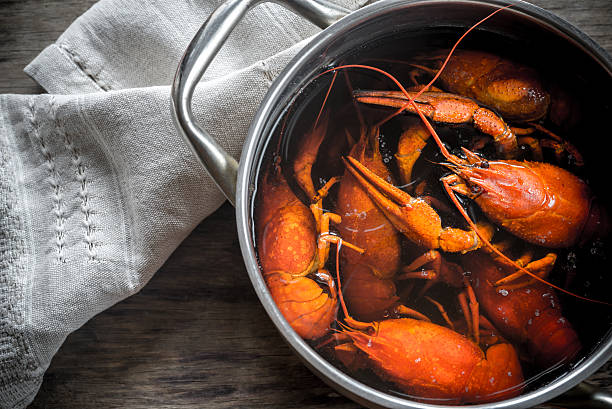 istock Pot with boiled crayfish on the wooden table 627070670