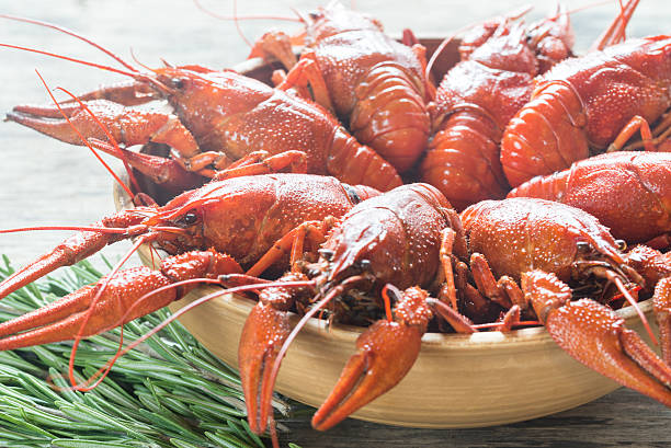 istock Bowl of boiled crayfish on the wooden table 627070838