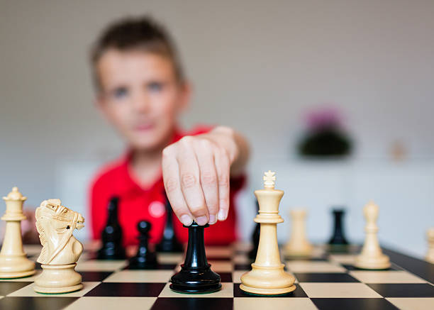 Child playing chess stock photo