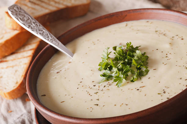 istock cream soup cauliflower and toast macro on the table. horizontal 627080880