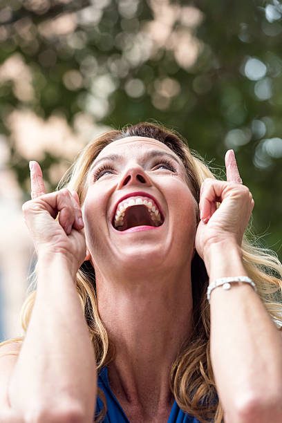 istock Urban Mature Blond Woman pointing up 627081190