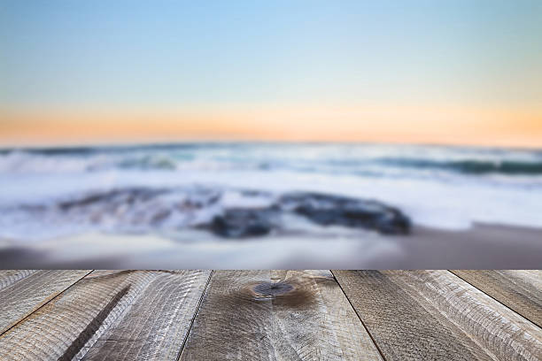 istock Wooden desk space and sea landscape 627081706