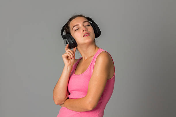 istock girl with headphones in studio 627081988