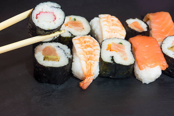 istock Pieces of sushi on a black stone 627091732
