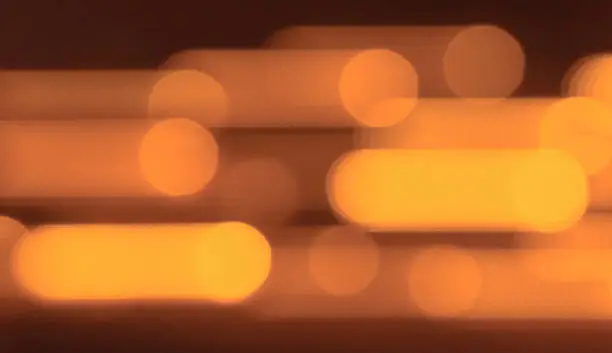 Photo of Moving orange lights. Blurred orange background.
