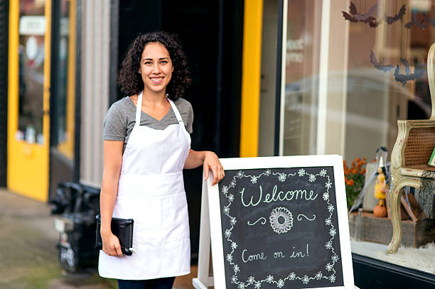 istock Young Hispanic female business owner standing outside her storefront 627092340