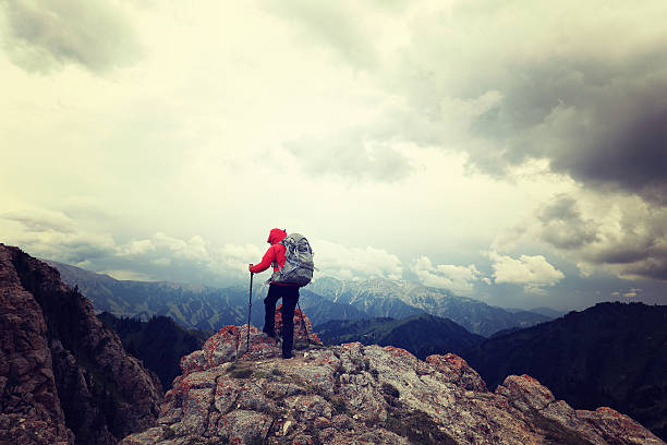 istock successful woman backpacker enjoy the view on mountain peak 627098496