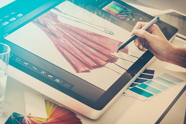 Graphic designer at work. Color samples. fashion fashionable designer clothing clothes cloth sketch design designing drawing draw stylist woman female red concept - stock image fashion designer photos stock pictures, royalty-free photos & images