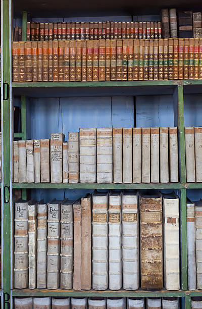 istock historic old book in library, wooden bookshelf 627101336
