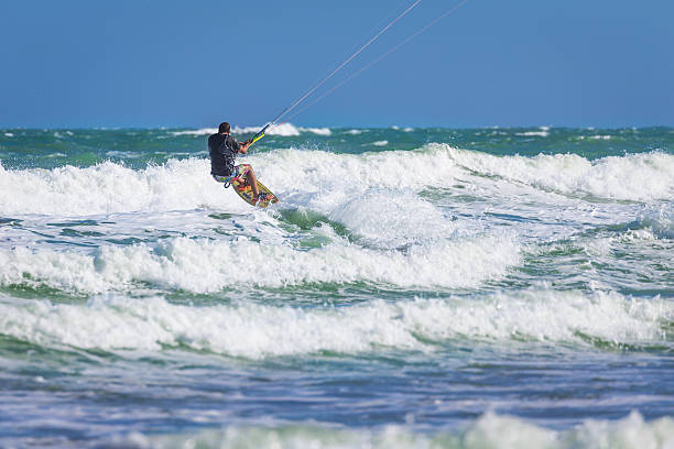 istock Wan riding kite surf on sea waves 627102322