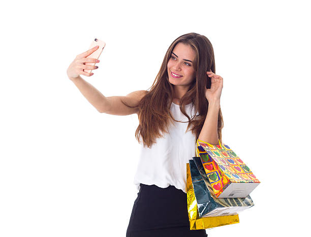 istock Woman with shopping bags making selfie 627103752