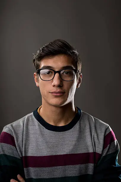 Photo of portrait of a young man with glasses on a jumper