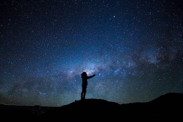 istock Man's silhouette reaching the milky way 627110718