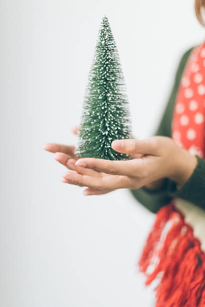 istock Beautiful woman with christmas tree on a light background 627111492