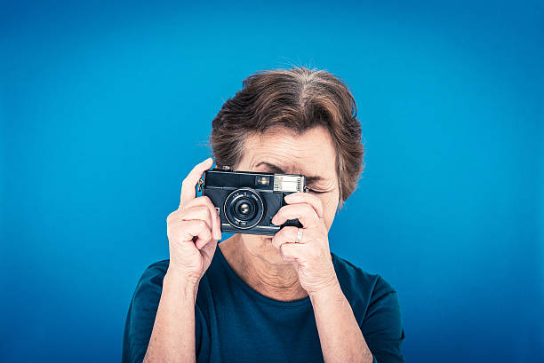 istock elderly woman blue background 627128882