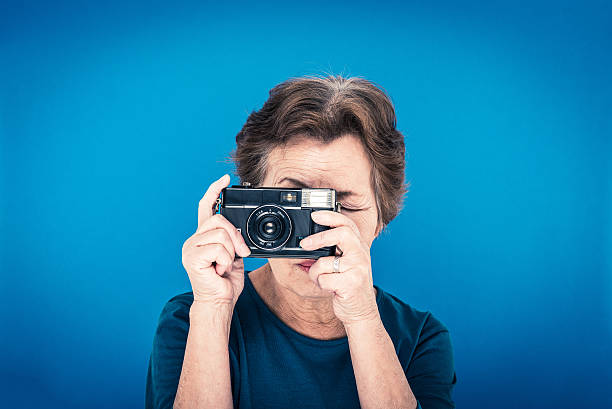 istock elderly woman blue background 627128906