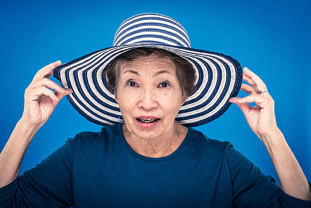istock elderly woman blue background 627129086