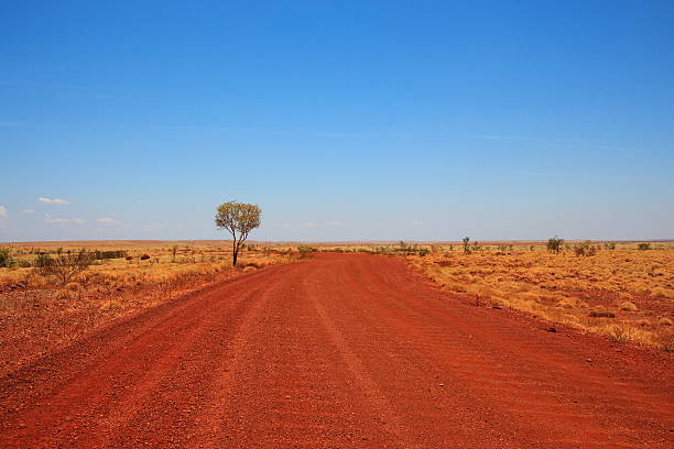 Dirt road across the Pilbara in Australian outback stock photo