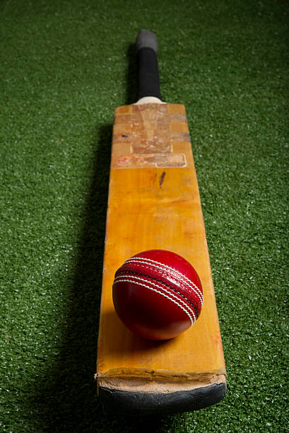 Cricket ball and bat on lawn Cricket ball and bat on lawn cricket stump photos stock pictures, royalty-free photos & images