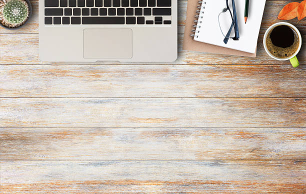 istock Notebook, glasses and cup of coffee wood table 627147542