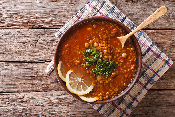 Thick Moroccan soup in a bowl on the table. horizontal Thick Moroccan Harira soup in a bowl close-up on the table. Horizontal view from above african culture food stock pictures, royalty-free photos & images