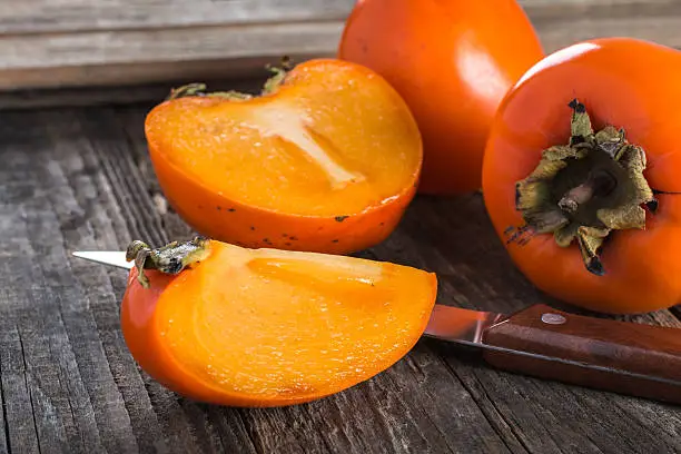 Persimmon fruit on wooden table