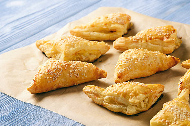 istock Puff pastry triangles filled with feta cheese and leek. 627156922