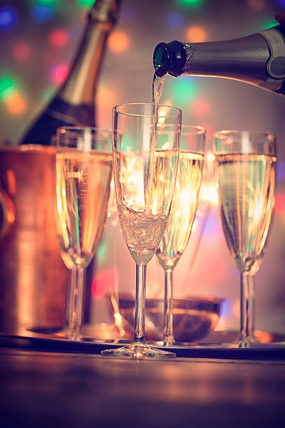 istock Pouring Champagne into Champagne Flutes 627157166
