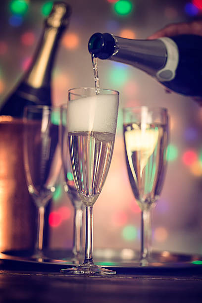 istock Pouring Champagne into Champagne Flutes 627157256